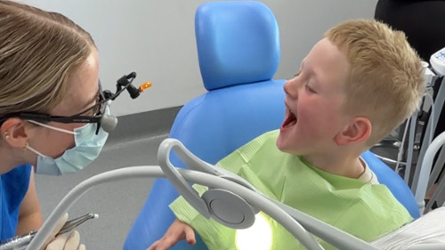 Child laughing at dentist