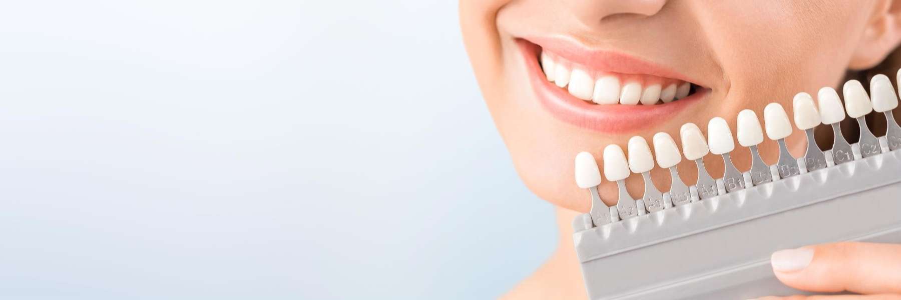 woman holding teeth whitening shades